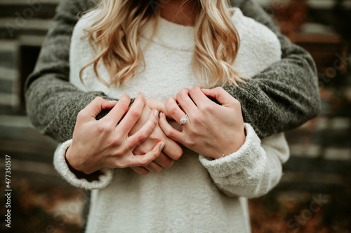 Couple holding hands with engagement ring  photo