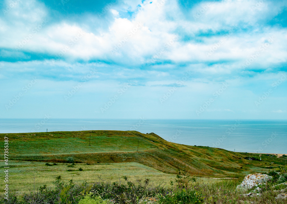 hills with grass on the seashore