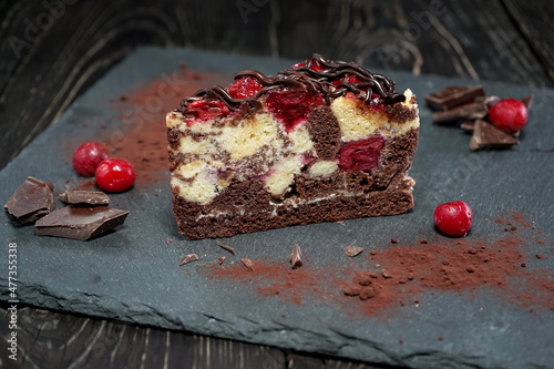 dessert chocolate cake beskit with cherries on black slate
 photo