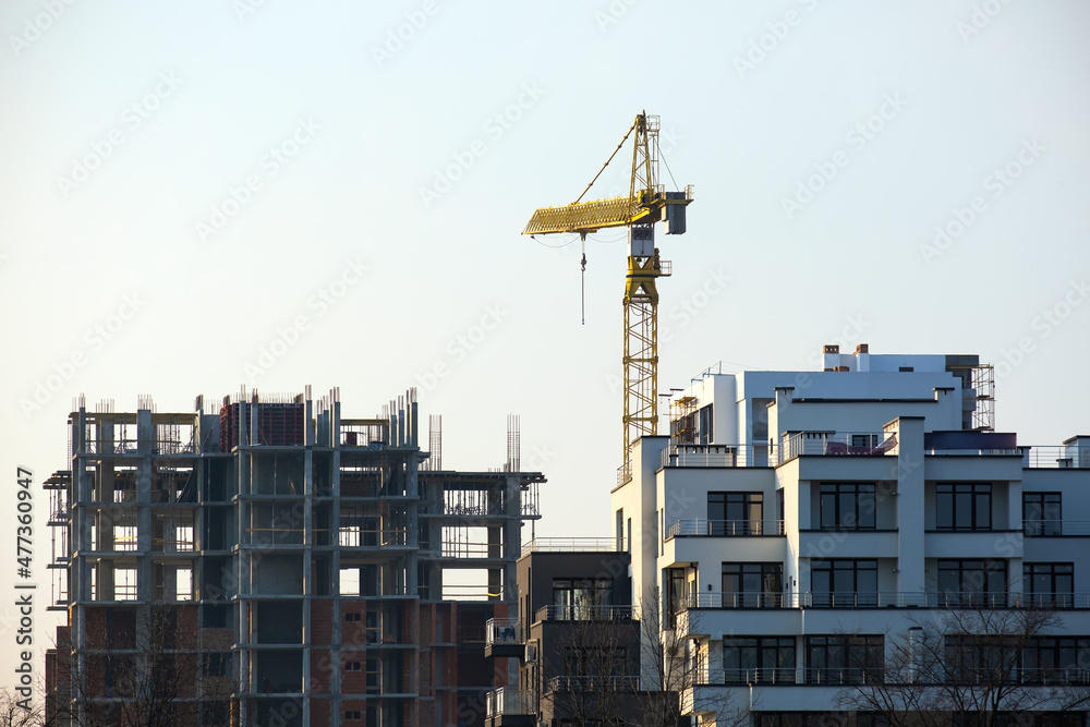 Tower cranes and high residential apartment buildings under construction. Real estate development