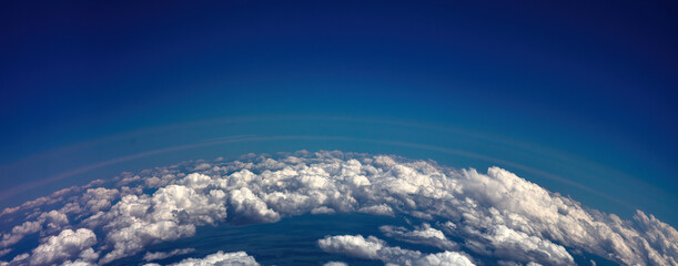 Curvature of planet earth. Aerial shot. Blue sky and clouds