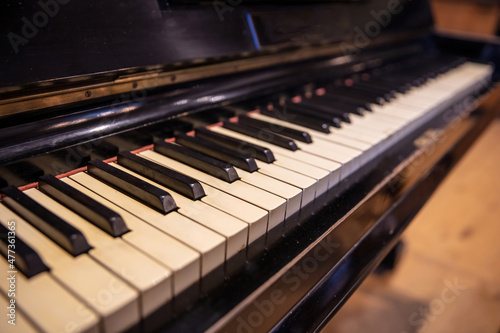 Piano keys on old wooden musical instrument. Piano keyboard closeup view © Rawf8