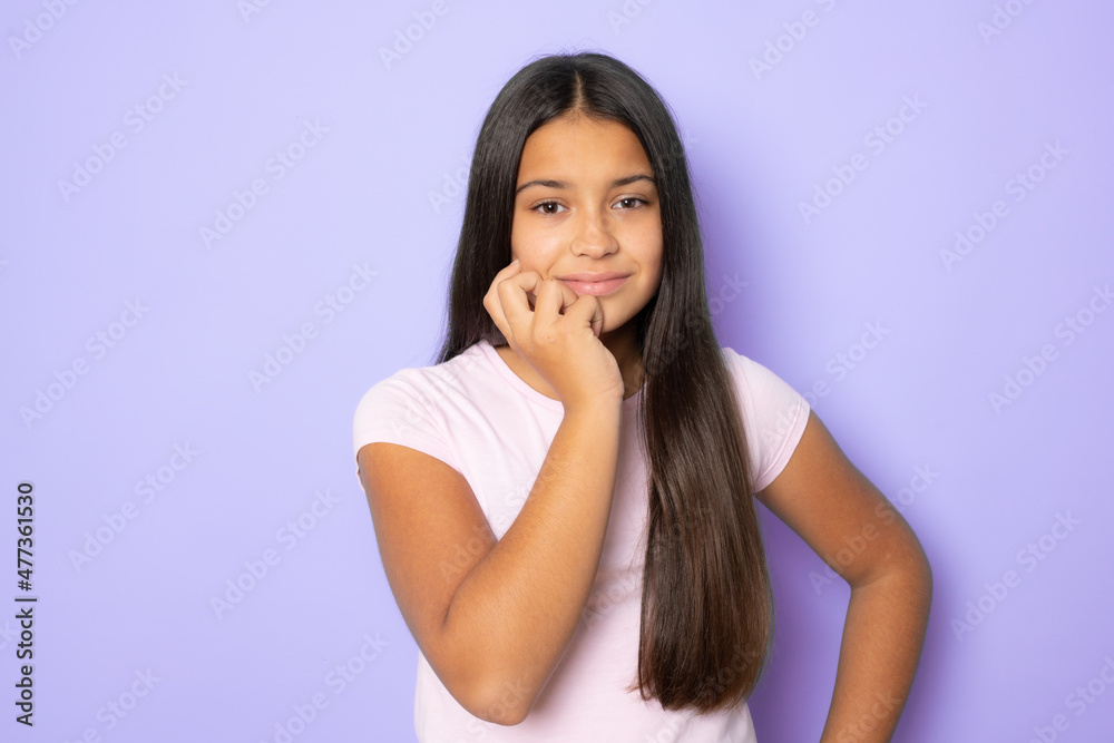 Doubtful brunette girl standing isolated over purple background. Doubtful brunette girl standing isolated over purple background.