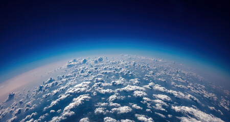 Curvature of planet earth. Aerial shot. Blue sky and clouds