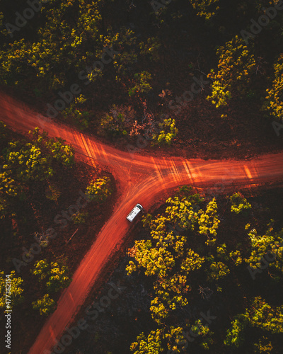 Aerial view of a vehicle driving a road near Kalkani crater, Undara national park, Mount Surprise, Queensland, Australia. photo