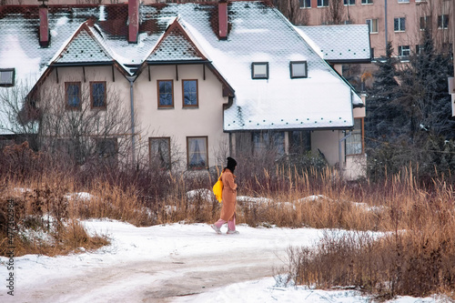 girl walking away from home