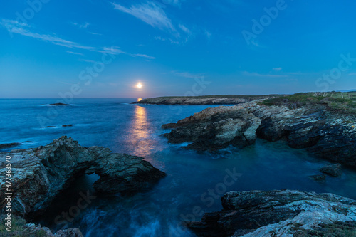 Full moon on the coast of Galicia  with lighthouse  natural rock arches  etc 