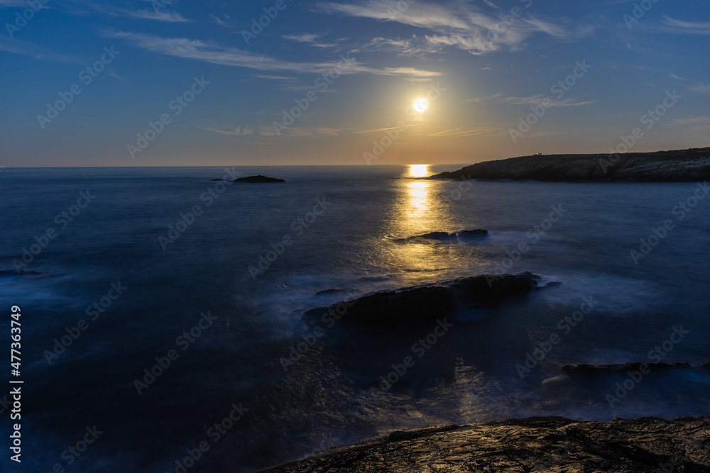 Full moon on the coast of Galicia, with lighthouse, natural rock arches, etc!