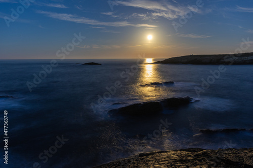 Full moon on the coast of Galicia  with lighthouse  natural rock arches  etc 