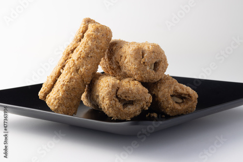 Indian traditional sweets for Makar Sankranti Or Lohri Mithai Gajak Also Known As Gur Gajjak, Gazak, Gachak Til Patti Or Papdi, Chikki Is Made Of Jaggery Gud, Almonds Badam And Pistachio photo