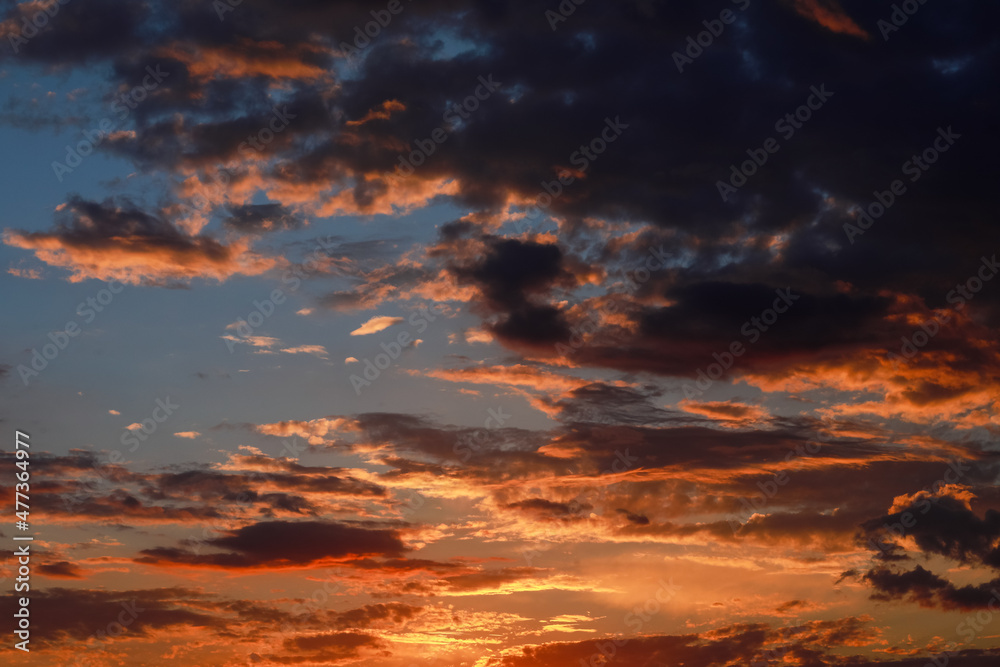 Gorgeous scenic of the sunrise or sunset with dark lining and cloud on the orange sky. Vibrant and Colorful background