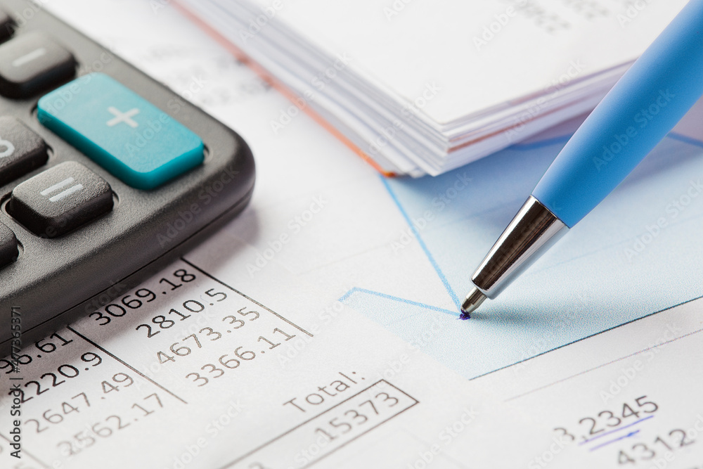Accounting document with pen,color diagram and checking financial chart. Concept of banking, financial report and financial audit. In blue color. Accounting document with pen,color diagram and checking financial chart. Concept of banking, financial report and financial audit. In blue color.