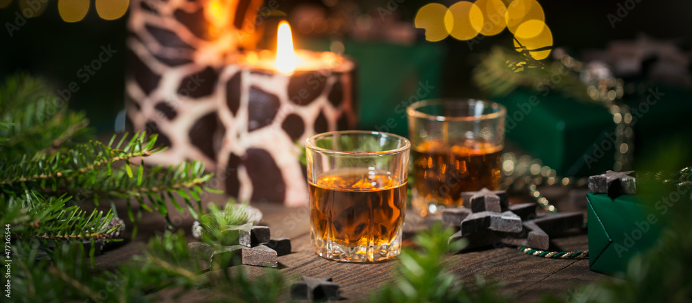 Two shot glasses of whiskey or bourbon with Holiday decoration Two shot glasses of whiskey or bourbon with Holiday decoration