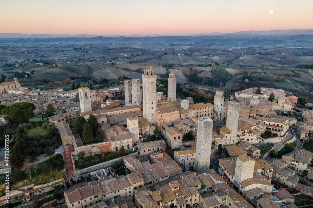 Aerial view of San Gimignano, a small old town with medieval tower at sunset, Siena, Tuscany, Italy. Aerial view of San Gimignano, a small old town with medieval tower at sunset, Siena, Tuscany, Italy.