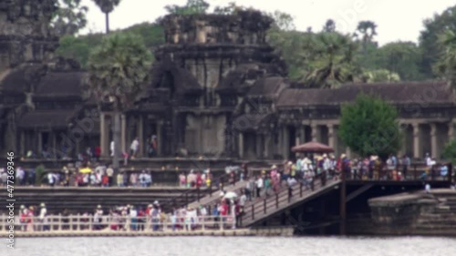 Blurred defocused view of crowd of local people in the entrance of Angkor Wat temple for celebrate the cambodian new year. Local festival in famous landmark, religious fest. photo