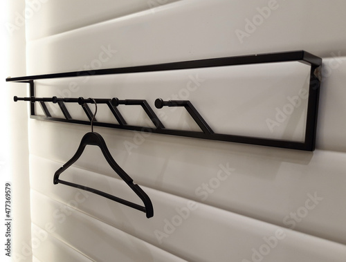 Obraz na plátně An empty hanger hangs on hooks in the store's fitting room