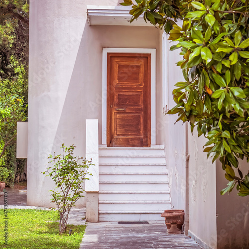 contemporary house entrance with white marble stairs and wooden door, Athens Greece