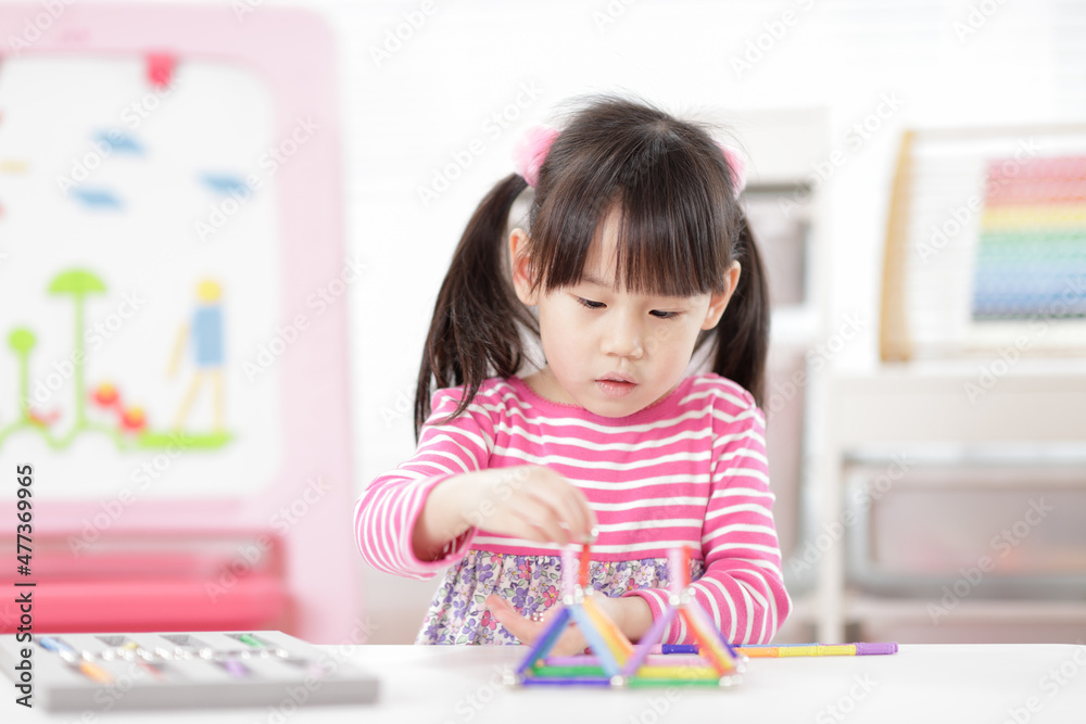 young girl playing creative 3d shape toy for homeschooling young girl playing creative 3d shape toy for homeschooling
