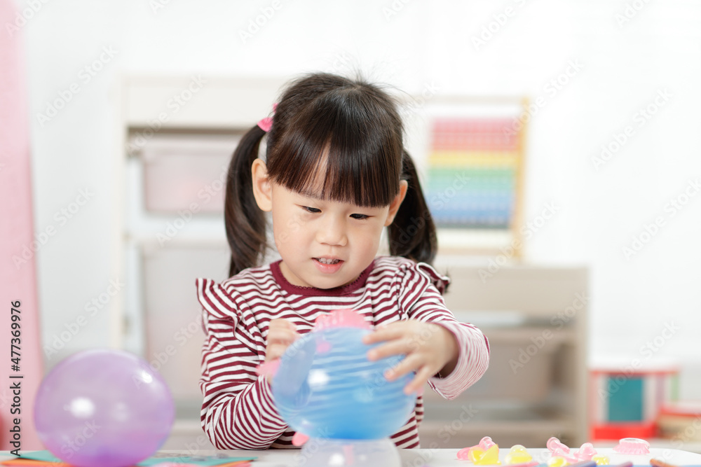 young girl making balloon craft for home schooling young girl making balloon craft for home schooling