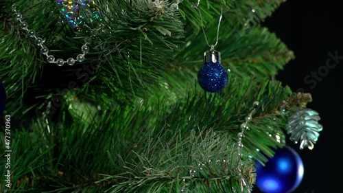 beautiful green christmas tree with garlands and gifts