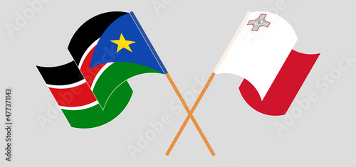 Crossed and waving flags of South Sudan and Malta
