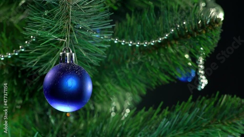 beautiful green christmas tree with garlands and gifts