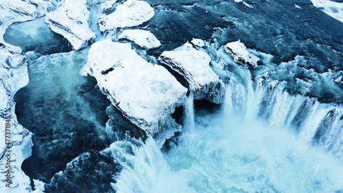 Godafoss aerial shot, famous waterfall in Iceland, Frozen waterfall in winter, a magical winter location of snow and ice, Pure glacial water with a huge current photo