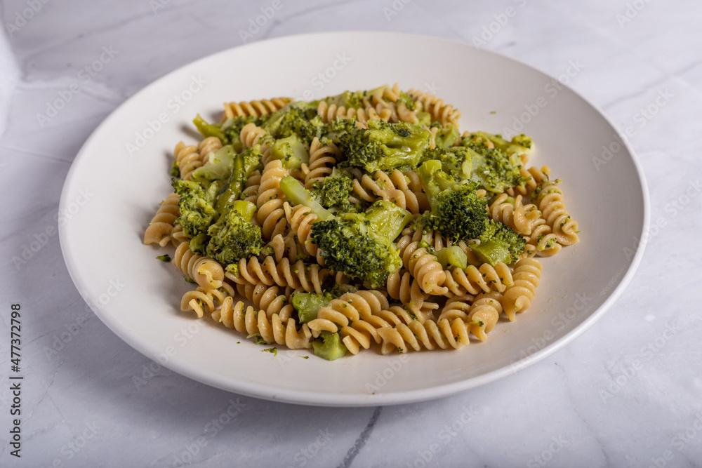 Fusilli pasta with broccoli on a white background. Typical vegetarian food.