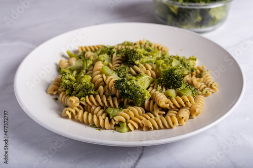 Fusilli pasta with broccoli on a white background. Typical vegetarian food.