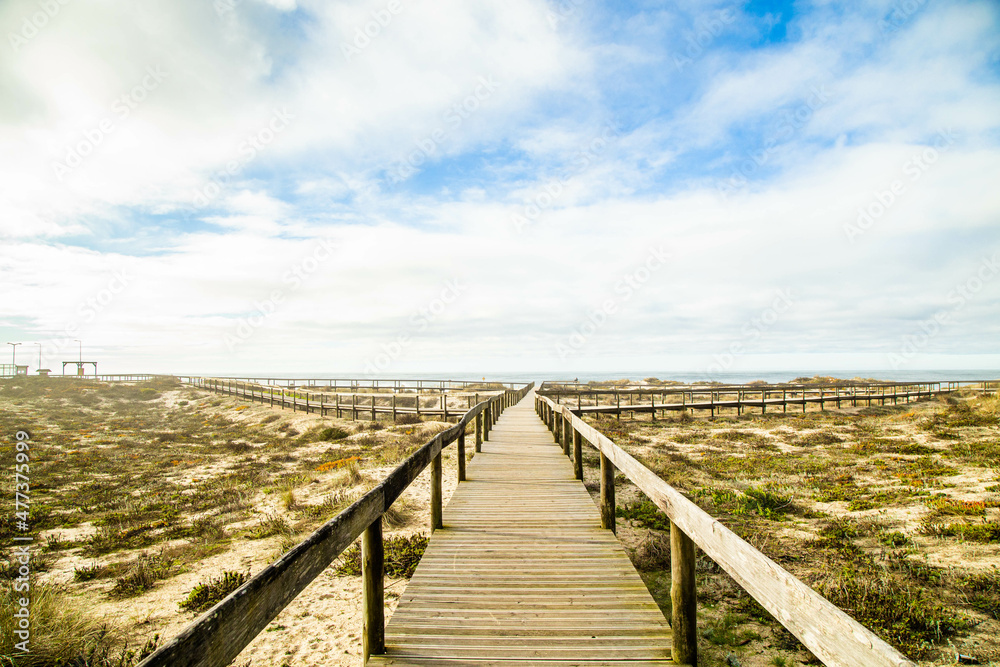Photo with blue sky and wooden path on Furadouro beach in Portugal