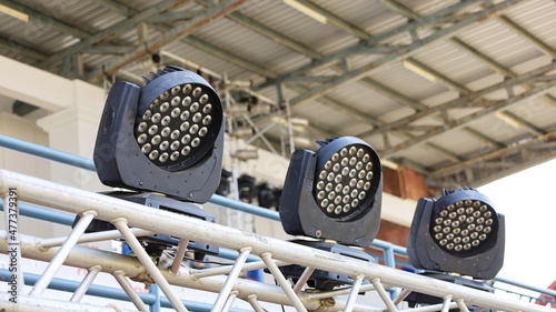 LED Moving Head Lights. Rotating LED lighting on metal stand for concert stage lighting on roof truss background. Selective focus