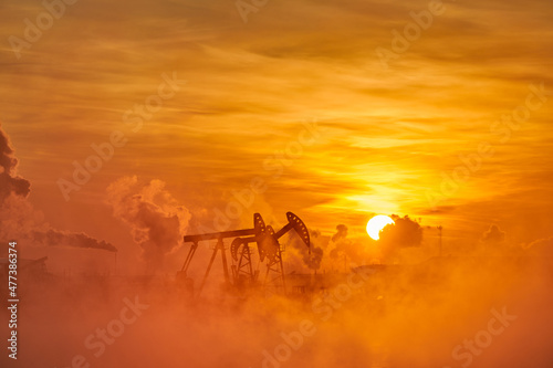 The pumping units in lakeside sunrise, Daqing oil fields Heilongjiang province, China.