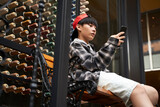 asian teenager looking at mobile phone outdoors