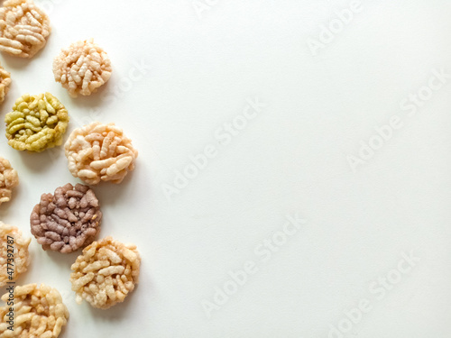 Thai sweets are arranged on white paper background. Thai fried sweet rice. Thai dressert concept.