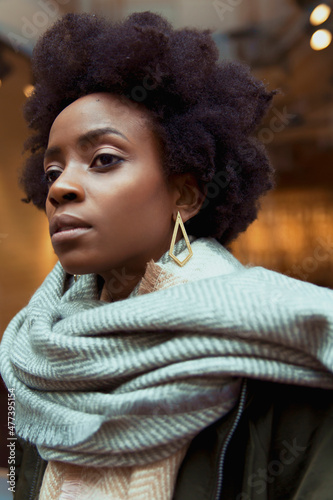 Portrait of Black woman in gray scarf looking away