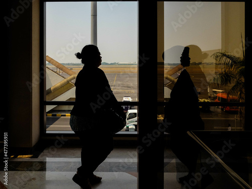 Silhouette of woman walking indoor