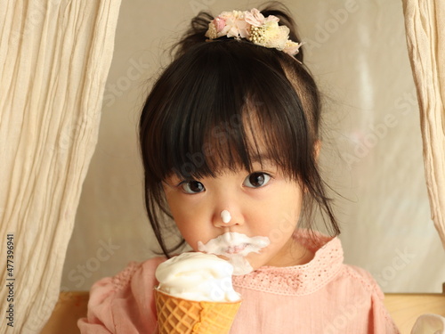 Young girl eating ice cream photo