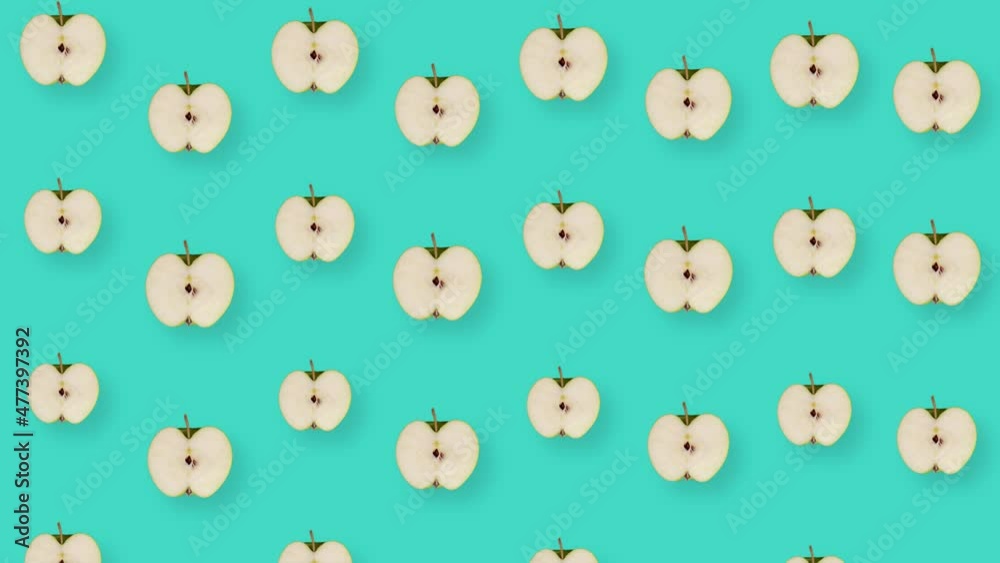 Colorful fruit pattern of fresh apples on blue background with shadows. Seamless pattern with apple sliced. Realistic animation. 4K video motion Colorful fruit pattern of fresh apples on blue background with shadows. Seamless pattern with apple sliced. Realistic animation. 4K video motion