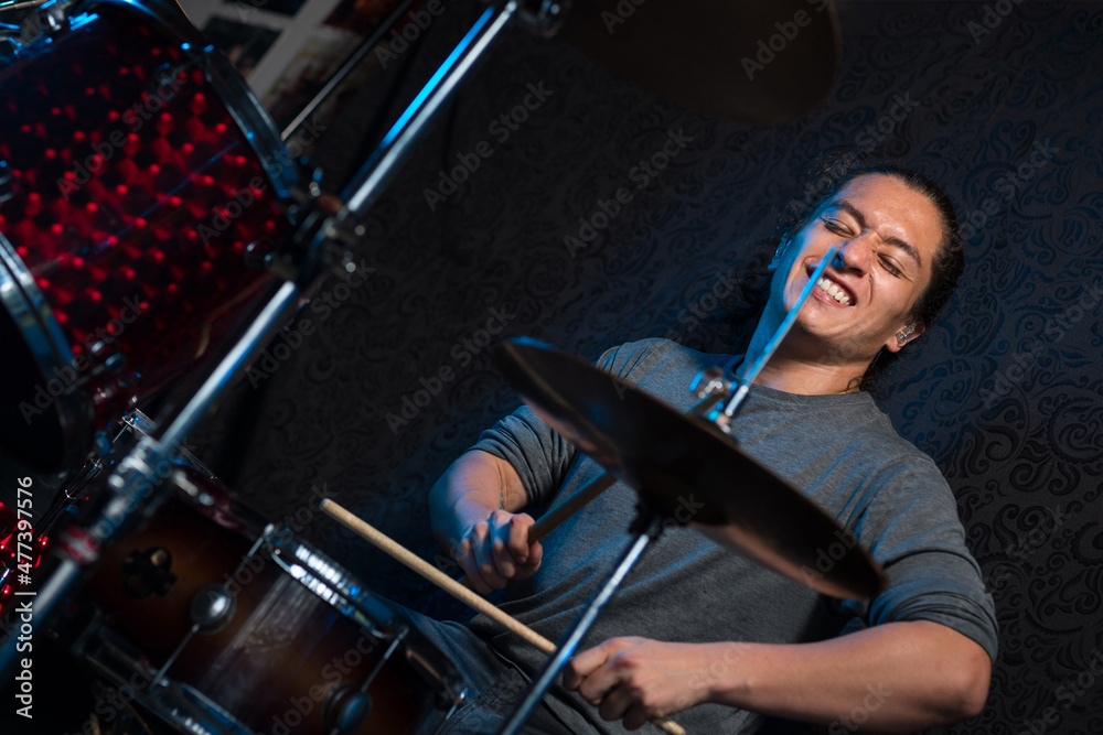 Fototapeta premium enjoying the music. Music student practicing with his musical instrument. Music teacher recording some tracks. Young drummer playing a song.