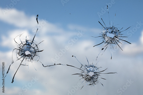 Bullet hole in dirty glass on a white background.