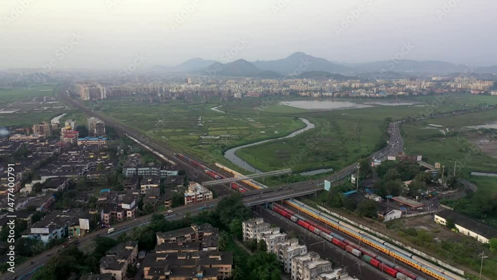 Suburban Scene with Buildings, Railway Station and Bridge in Vasai, Mumbai, India - aerial drone shot Suburban Scene with Buildings, Railway Station and Bridge in Vasai, Mumbai, India - aerial drone shot