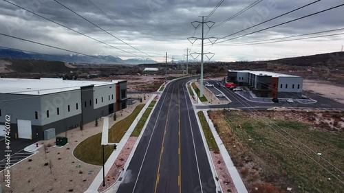 Aerial Shot Going Between Power Lines and Warehouses at Bringhurst Station in Bluffdale Utah. Forward Movement photo