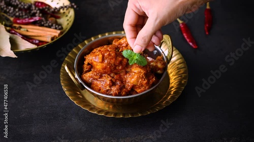 woman hand serving red chicken roast curry Goan chicken vindaloo Butter chicken Murgh Makhani hot spicy dish 4K video footage Kerala Punjab India North Indian non-vegetarian cuisine Garam Masala tikka