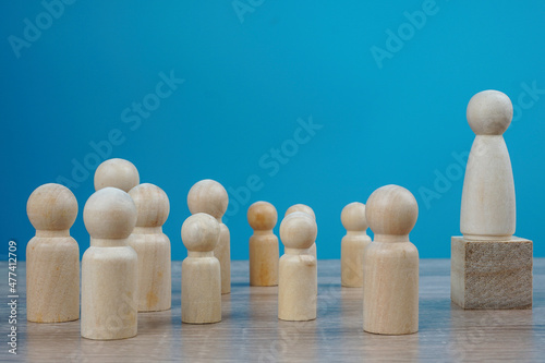Female wood sign on a cube as a leader. Leadership, equality, politics concept 