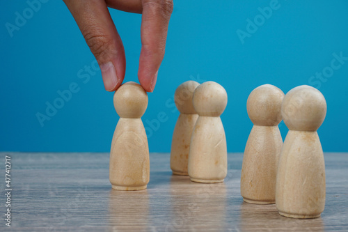 Leadership concept. Woman hand choose one of the icon to bring forward. 