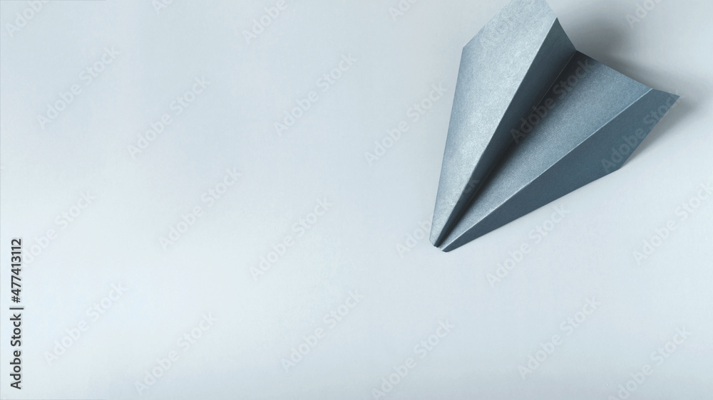 Banner light blue paper airplane on a light background copy space concept. Banner light blue paper airplane on a light background copy space concept.