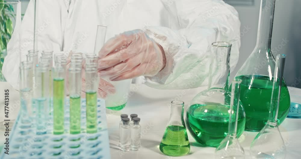 chemical reaction. liquid is poured into the flask, smoke or steam comes out of the flask. laboratory desk and instruments. experiences chemical reaction. liquid is poured into the flask, smoke or steam comes out of the flask. laboratory desk and instruments. experiences