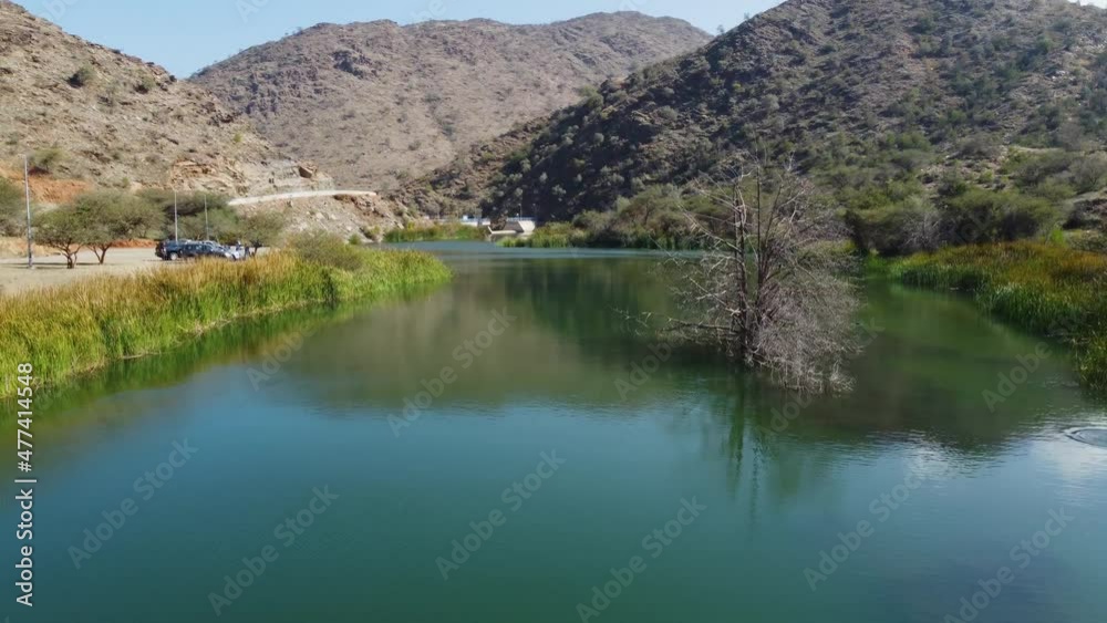Aerial drone view over water, approaching the Wadi dark dam, in Al Baha, Saudi Arabia Aerial drone view over water, approaching the Wadi dark dam, in Al Baha, Saudi Arabia