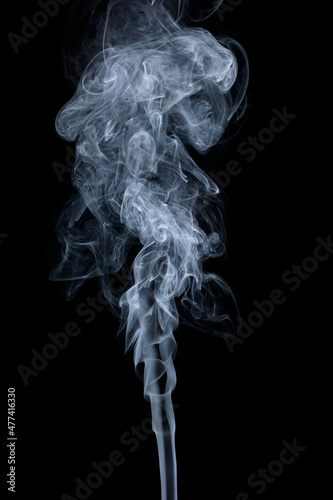 Clouds of curls of smoke on a black background.