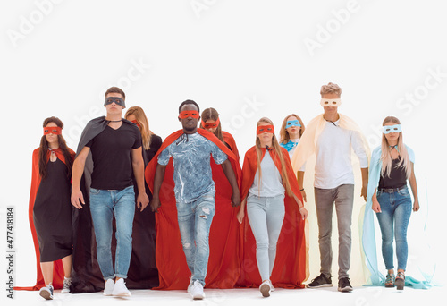 young people in colorful superhero cloaks standing together. photo